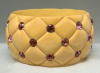wide quilt carved soft yellow bakelite bangle with pink rhinestones